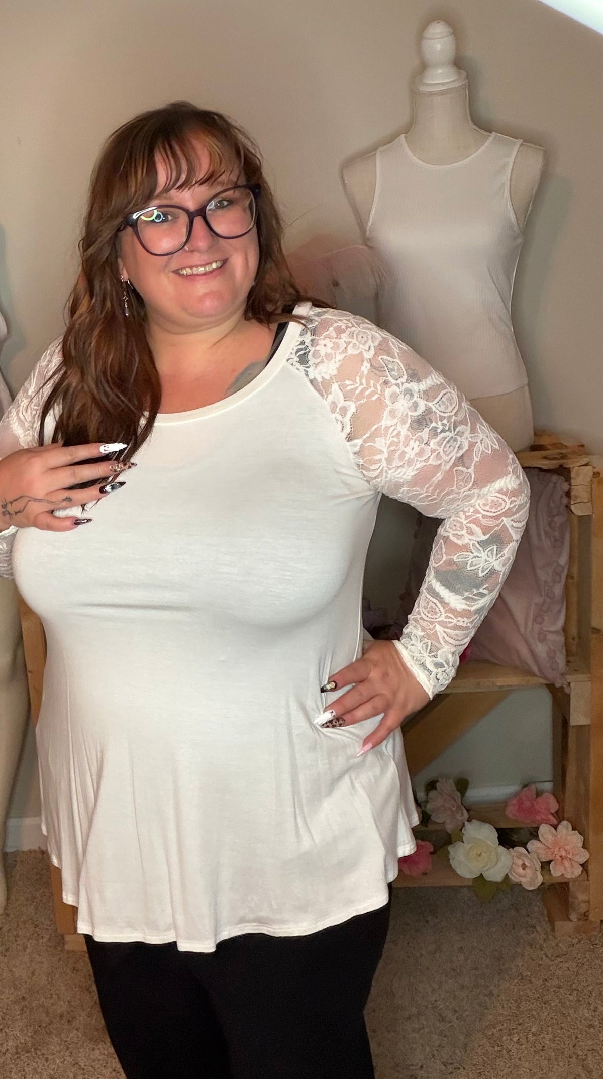 Side view of ivory floral lace sleeve top modeled